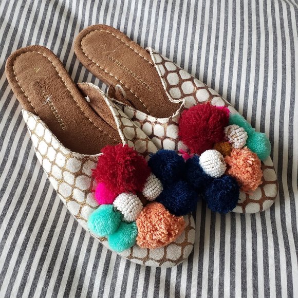 mules with pom poms
